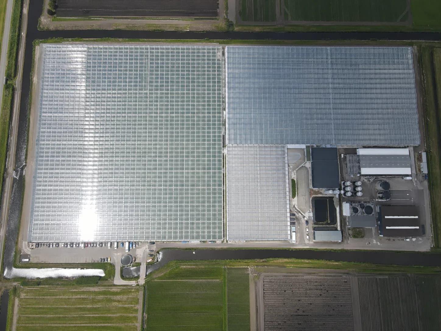 Aerial view of large greenhouse areas with technical installations