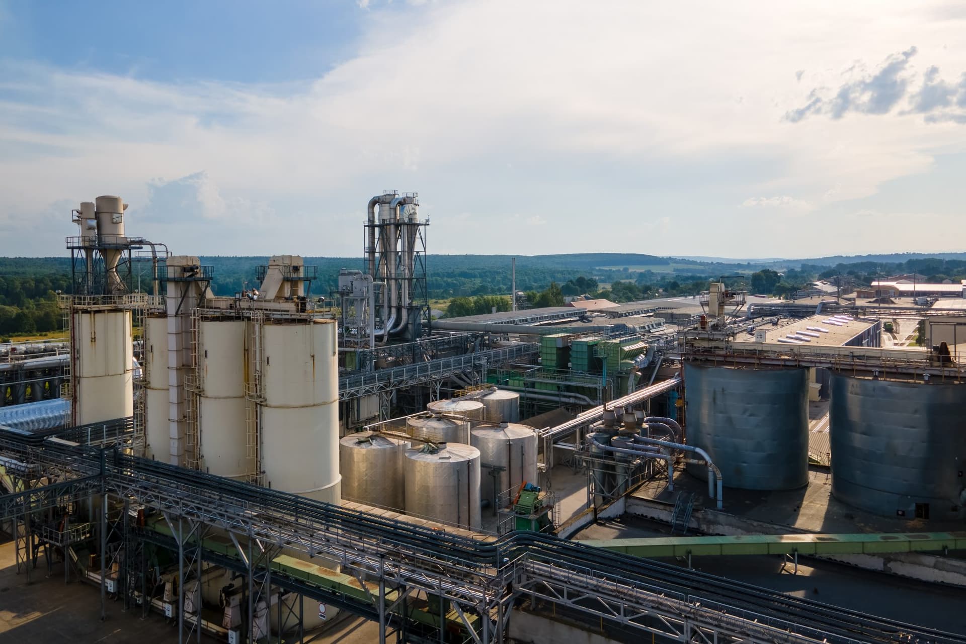 Industrial production site with silos, pipework and storage tanks