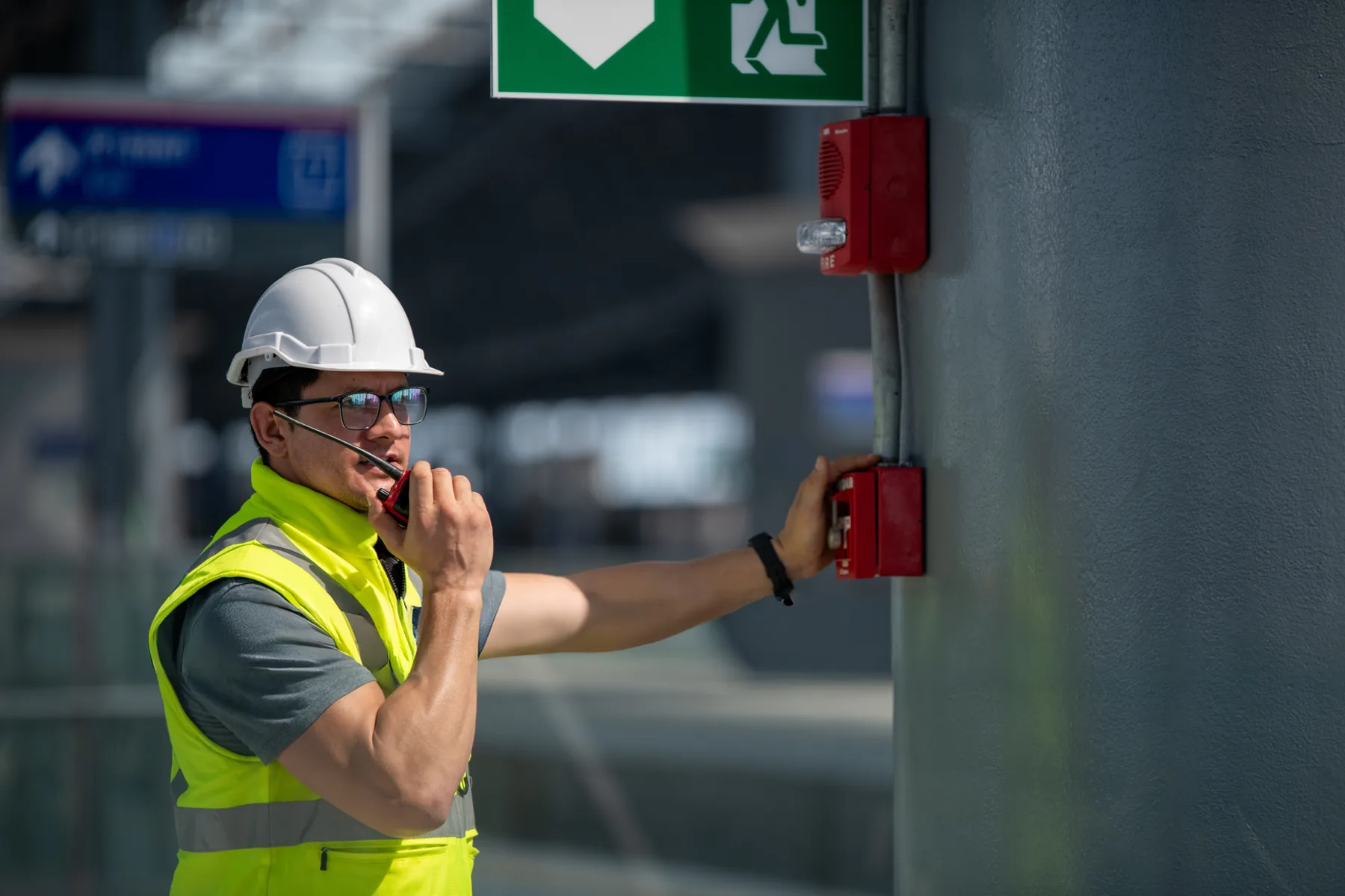 Industrial operator checking an emergency system in a production environment