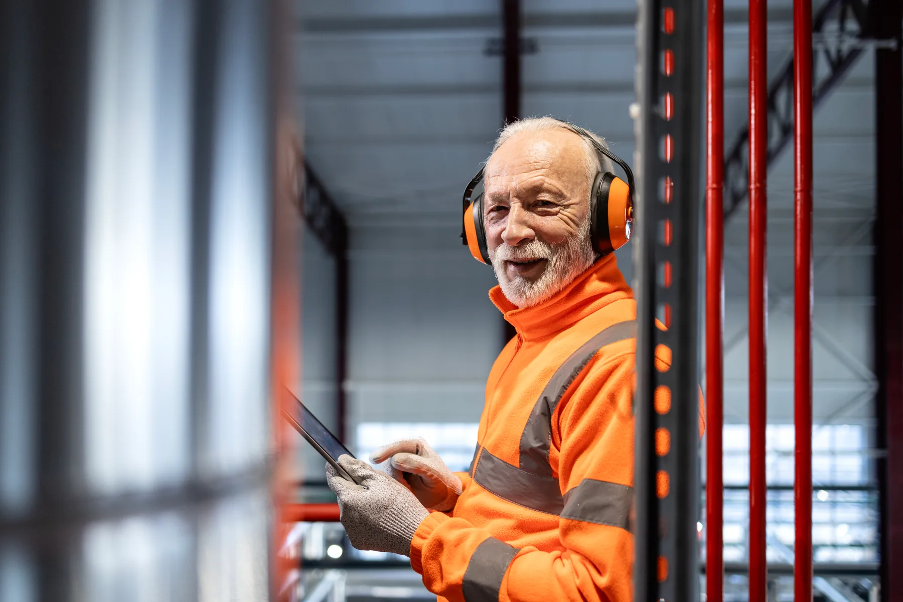 Industrial operations manager using a tablet in a production environment