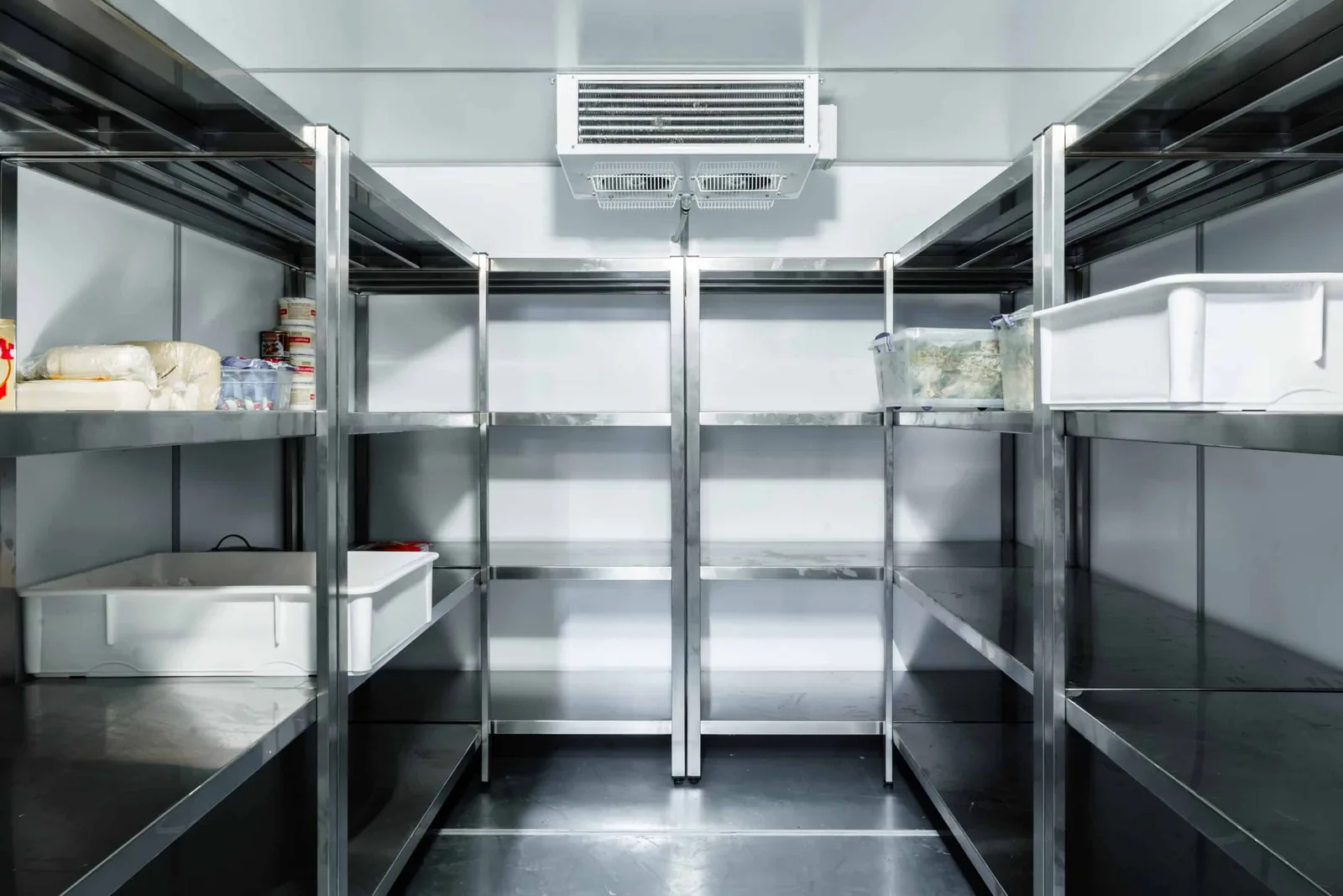 Walk-in cold store in a hospitality business, with stainless steel shelving and an evaporator unit on the ceiling